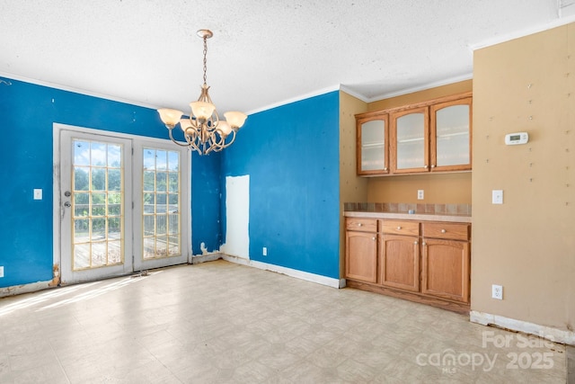 6314 Providence Church Rd, Vale, NC 28168 - unfurnished dining area with a textured ceiling, crown molding, a chandelier, and light flooring
