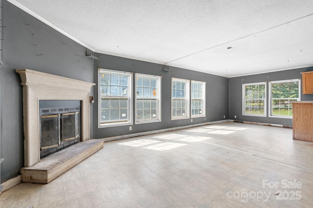 6314 Providence Church Rd, Vale, NC 28168 - unfurnished living room featuring a textured ceiling, a glass covered fireplace, ornamental molding, and tile patterned floors