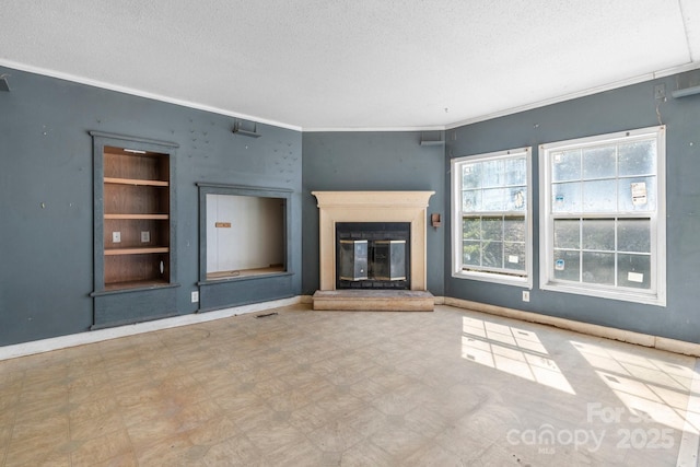 6314 Providence Church Rd, Vale, NC 28168 - unfurnished living room featuring a textured ceiling, tile patterned floors, crown molding, and a glass covered fireplace