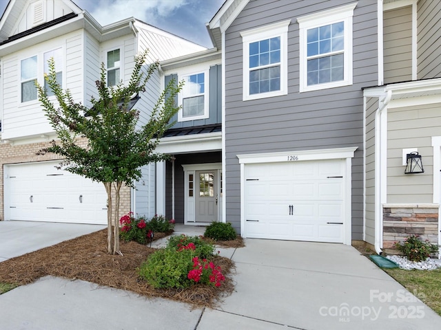 1206 Pebble Grove Dr, Clover, SC 29710 - view of property with an attached garage, concrete driveway, a standing seam roof, and a metal roof