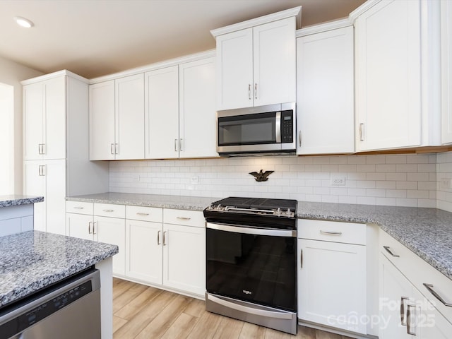 1206 Pebble Grove Dr, Clover, SC 29710 - kitchen featuring appliances with stainless steel finishes, white cabinets, light wood-type flooring, tasteful backsplash, and recessed lighting