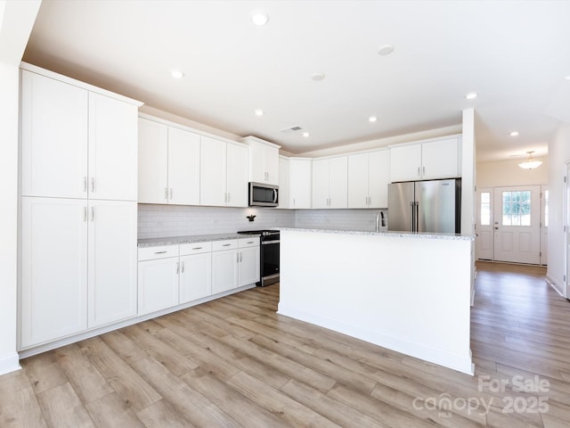 1206 Pebble Grove Dr, Clover, SC 29710 - kitchen featuring stainless steel appliances, light wood finished floors, white cabinets, and recessed lighting