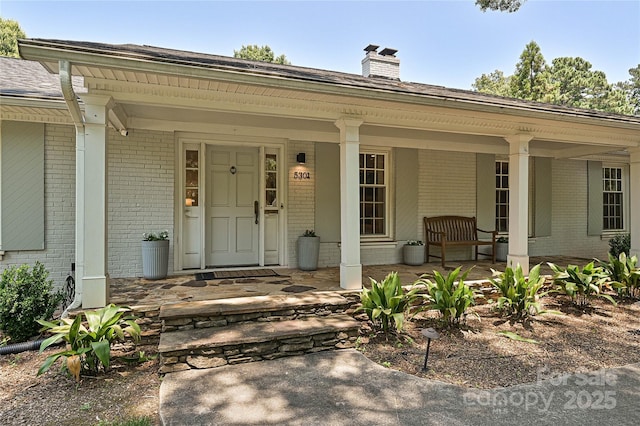 5301 Addison Dr, Charlotte, NC 28211 - entrance to property featuring brick siding, covered porch, and a chimney