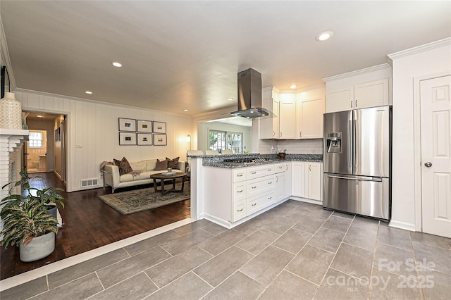 5301 Addison Dr, Charlotte, NC 28211 - kitchen with stainless steel appliances, island exhaust hood, ornamental molding, white cabinetry, and open floor plan