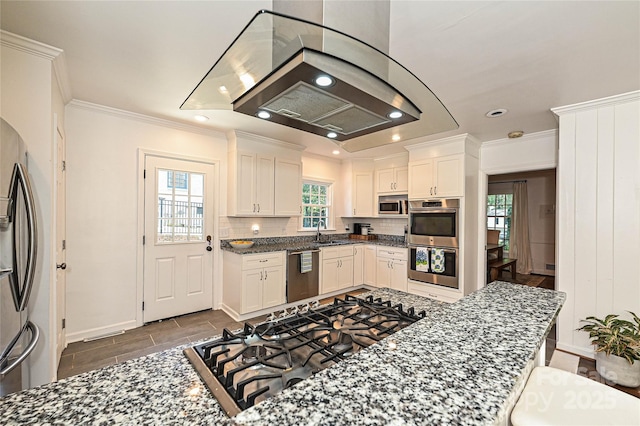 5301 Addison Dr, Charlotte, NC 28211 - kitchen with appliances with stainless steel finishes, ornamental molding, white cabinetry, decorative backsplash, and dark stone countertops