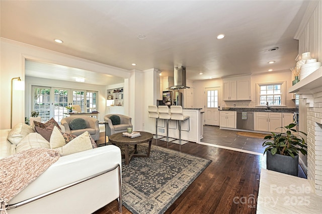 5301 Addison Dr, Charlotte, NC 28211 - living room with a brick fireplace, crown molding, recessed lighting, and dark wood-style flooring