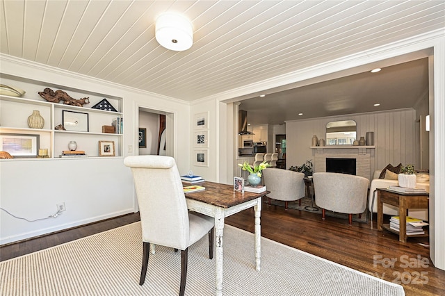 5301 Addison Dr, Charlotte, NC 28211 - dining area featuring ornamental molding, wood finished floors, and a fireplace