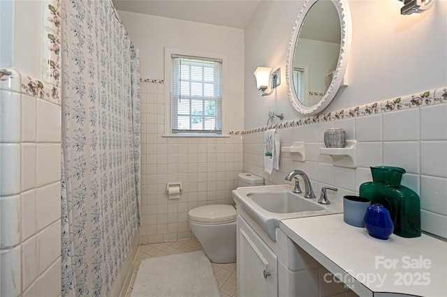 5301 Addison Dr, Charlotte, NC 28211 - bathroom with tile walls, tile patterned flooring, vanity, wainscoting, and curtained shower