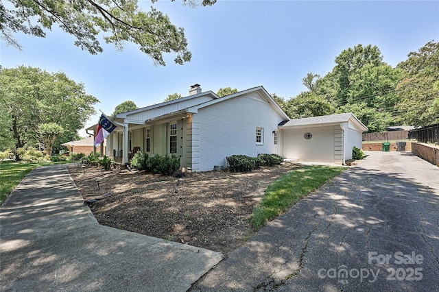 5301 Addison Dr, Charlotte, NC 28211 - view of property exterior with brick siding, asphalt driveway, and a chimney