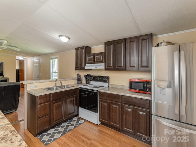 5 Shenandoah Rd, Asheville, NC 28805 - kitchen with stainless steel appliances, under cabinet range hood, light countertops, a peninsula, and light wood-style flooring