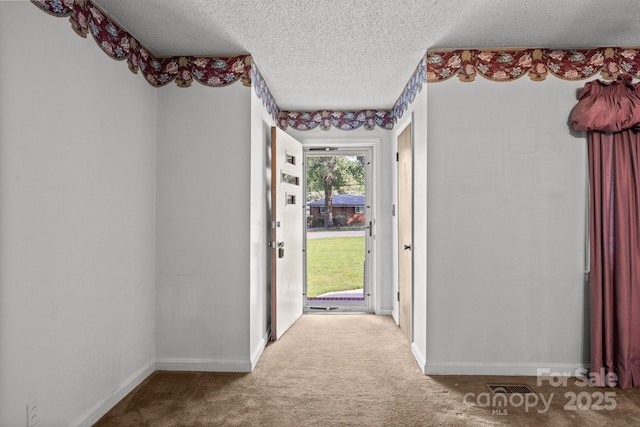331 Elwood St, Kannapolis, NC 28081 - doorway with a textured ceiling and carpet
