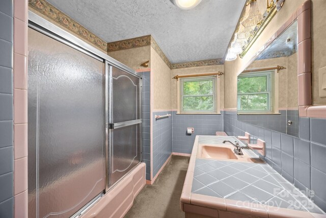 331 Elwood St, Kannapolis, NC 28081 - bathroom featuring a textured ceiling, vanity, enclosed tub / shower combo, wainscoting, and tile walls