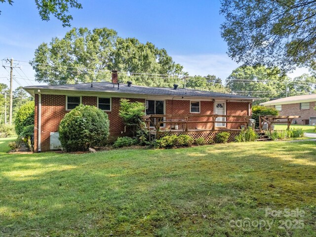 331 Elwood St, Kannapolis, NC 28081 - back of property with a wooden deck, a lawn, and brick siding
