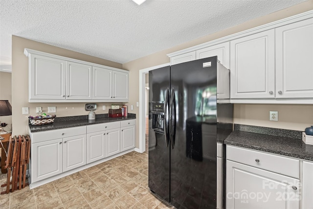 1921 Williford Woods Ln, Rock Hill, SC 29730 - kitchen featuring black fridge, dark countertops, and white cabinetry