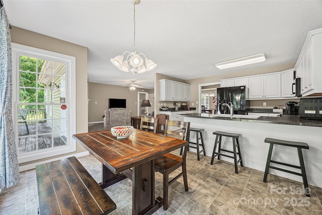 1921 Williford Woods Ln, Rock Hill, SC 29730 - dining area with a chandelier, a textured ceiling, and a ceiling fan