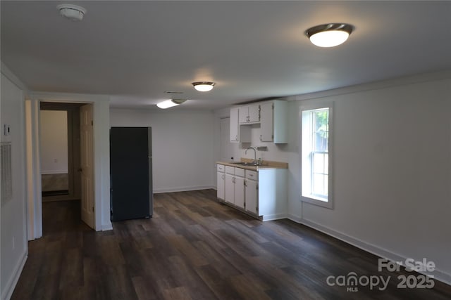 127 Setzer St, Spindale, NC 28160 - kitchen with dark wood-type flooring, white cabinetry, and light countertops