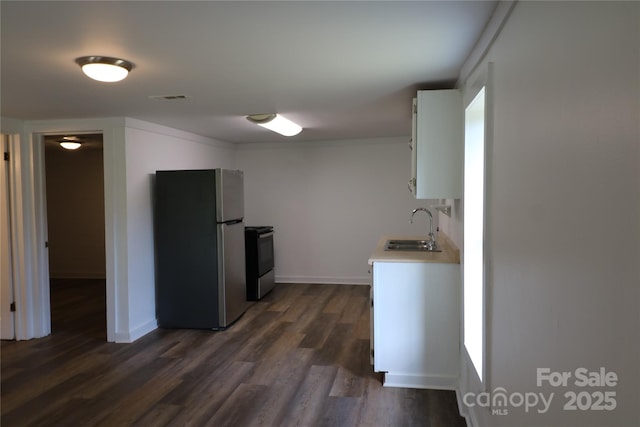 127 Setzer St, Spindale, NC 28160 - kitchen featuring stainless steel appliances, light countertops, dark wood-style flooring, and white cabinets