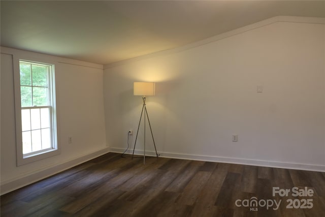 127 Setzer St, Spindale, NC 28160 - spare room featuring dark wood-style floors and vaulted ceiling