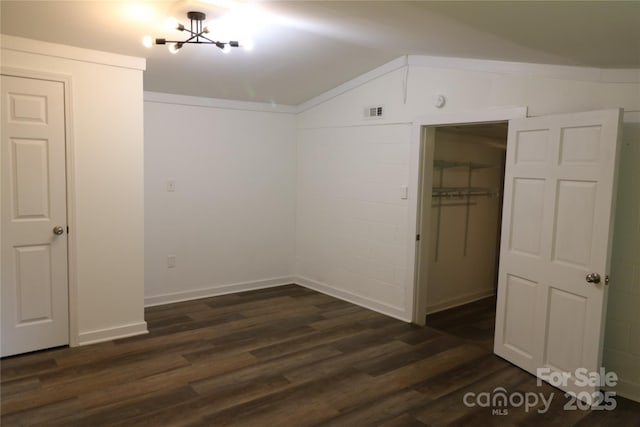 127 Setzer St, Spindale, NC 28160 - unfurnished bedroom with lofted ceiling, dark wood finished floors, a closet, a walk in closet, and a chandelier