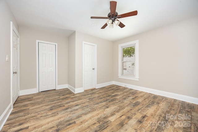 900 N Salisbury Ave, Spencer, NC 28159 - unfurnished bedroom with wood finished floors, a closet, and ceiling fan