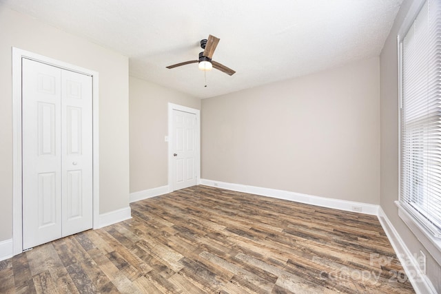 900 N Salisbury Ave, Spencer, NC 28159 - unfurnished bedroom featuring wood finished floors, a closet, and ceiling fan