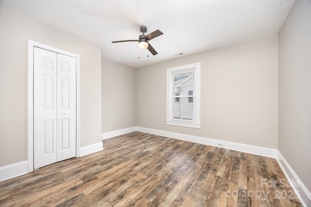 900 N Salisbury Ave, Spencer, NC 28159 - unfurnished bedroom featuring wood finished floors, a closet, and a ceiling fan