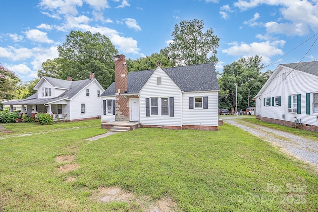 900 N Salisbury Ave, Spencer, NC 28159 - view of front of property featuring driveway, roof with shingles, a chimney, and a front lawn