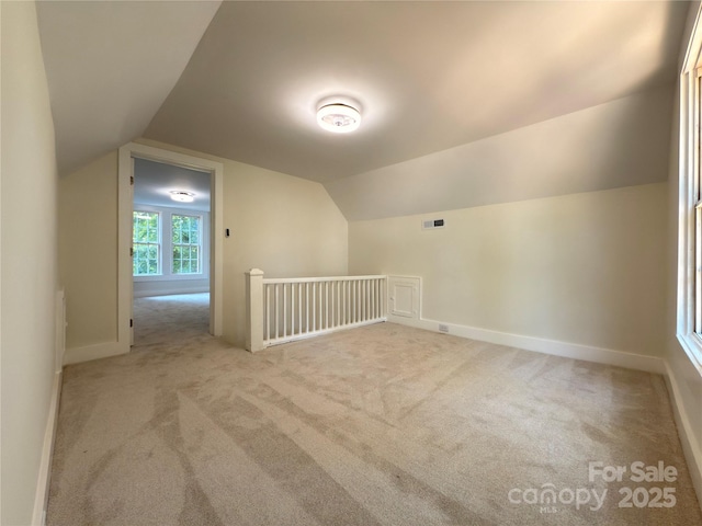 179 Duval St NW, Concord, NC 28025 - additional living space with carpet flooring and vaulted ceiling