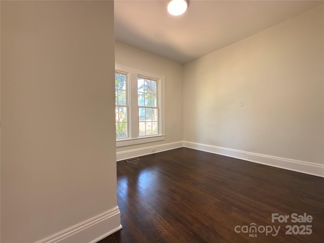 179 Duval St NW, Concord, NC 28025 - spare room with baseboards and dark wood finished floors