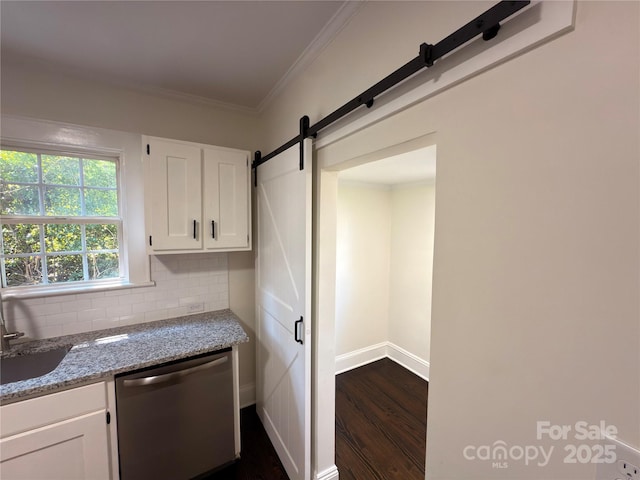 179 Duval St NW, Concord, NC 28025 - kitchen featuring stainless steel dishwasher, a barn door, white cabinetry, tasteful backsplash, and ornamental molding