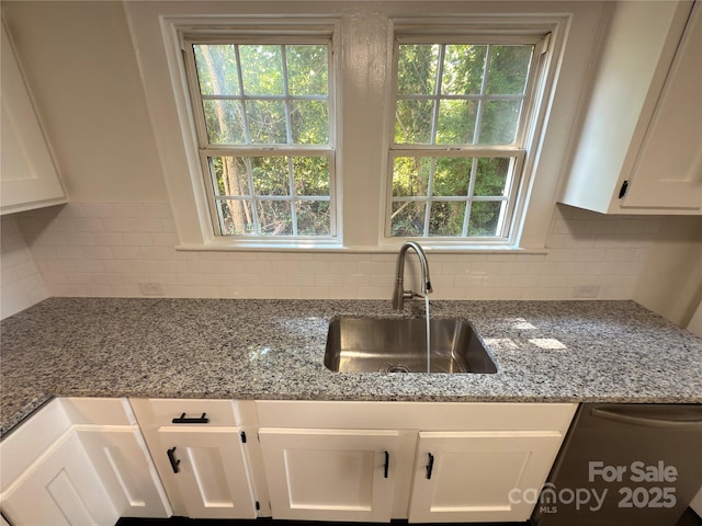 179 Duval St NW, Concord, NC 28025 - kitchen with white cabinets, decorative backsplash, light stone countertops, and healthy amount of natural light