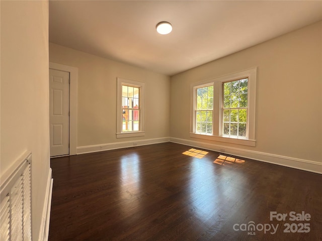 179 Duval St NW, Concord, NC 28025 - empty room featuring baseboards and dark wood-style flooring