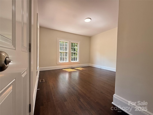 179 Duval St NW, Concord, NC 28025 - spare room featuring dark wood-style floors and baseboards