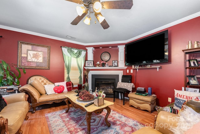 5448 Wyalong Dr, Charlotte, NC 28227 - living area featuring a ceiling fan, wood finished floors, a glass covered fireplace, and crown molding