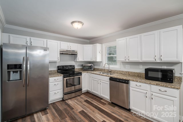 108 Graham St, Stanley, NC 28164 - kitchen with appliances with stainless steel finishes, under cabinet range hood, white cabinets, ornamental molding, and light stone counters