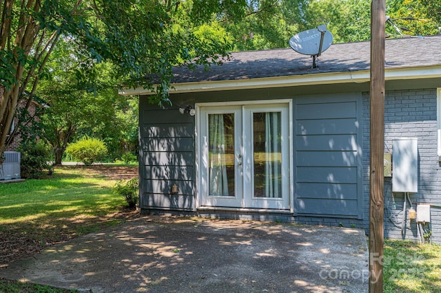 108 Graham St, Stanley, NC 28164 - view of side of property with french doors, brick siding, a yard, a patio, and roof with shingles