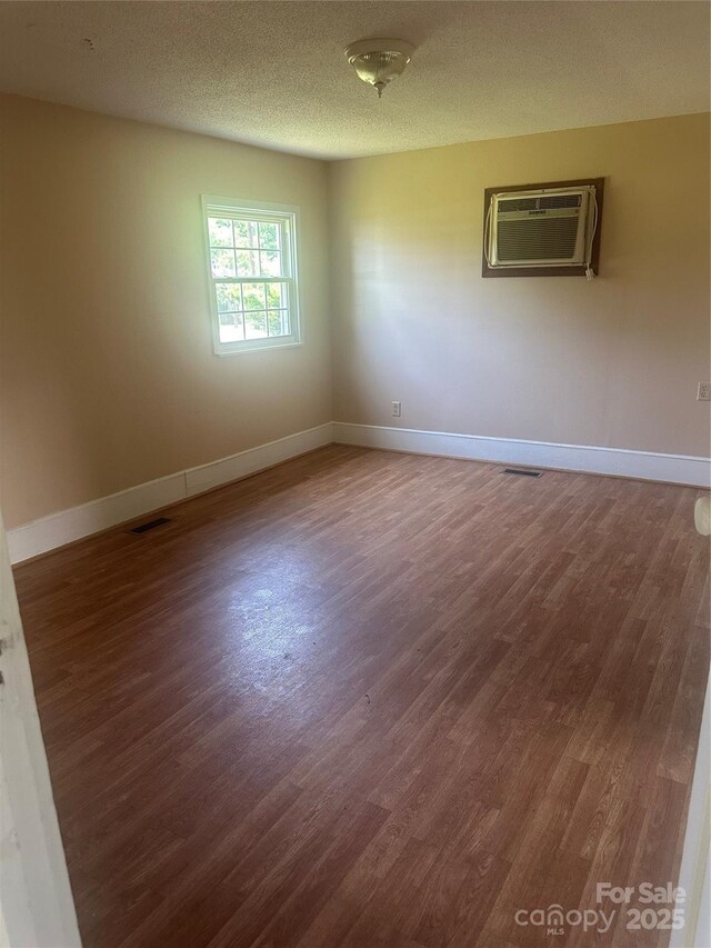 162 Bartley St, Spindale, NC 28160 - empty room featuring a wall unit AC and wood finished floors