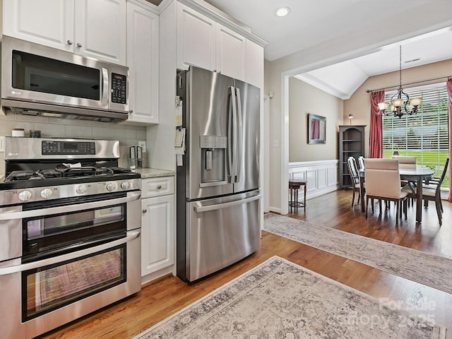1842 Caroline Way, Fort Mill, SC 29715 - kitchen featuring stainless steel appliances, a chandelier, vaulted ceiling, white cabinetry, and light countertops