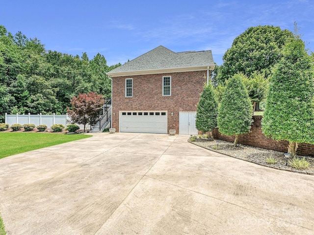 1842 Caroline Way, Fort Mill, SC 29715 - view of property exterior featuring stairway, brick siding, a garage, driveway, and a shingled roof