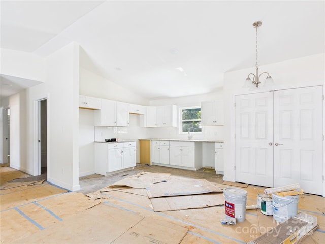39 Pearl St, Granite Falls, NC 28630 - kitchen with white cabinetry, a chandelier, pendant lighting, and vaulted ceiling