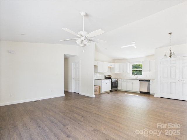 39 Pearl St, Granite Falls, NC 28630 - unfurnished living room featuring vaulted ceiling, a chandelier, wood finished floors, and a ceiling fan