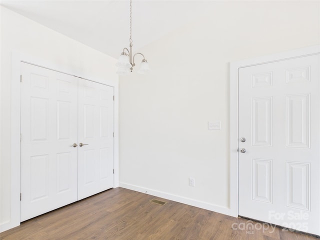 39 Pearl St, Granite Falls, NC 28630 - unfurnished bedroom with a chandelier, dark wood-type flooring, and a closet