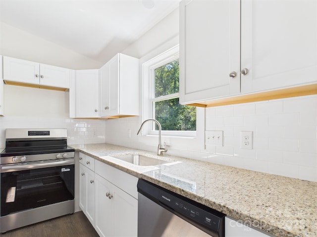 39 Pearl St, Granite Falls, NC 28630 - kitchen with stainless steel appliances, white cabinetry, light stone countertops, tasteful backsplash, and lofted ceiling