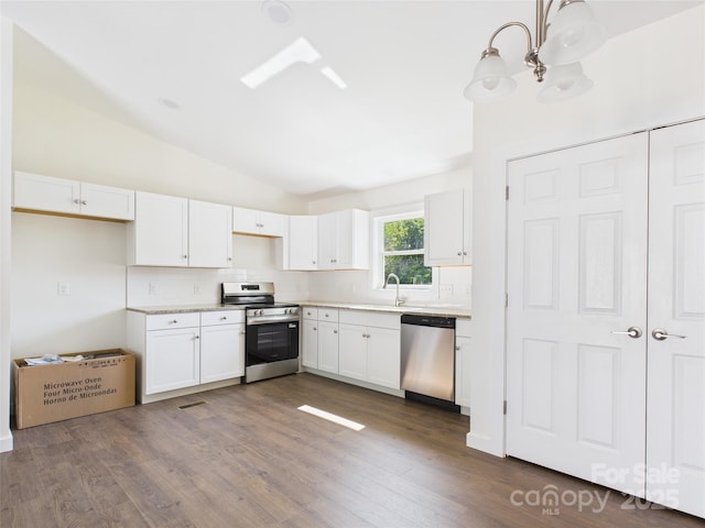 39 Pearl St, Granite Falls, NC 28630 - kitchen featuring stainless steel appliances, backsplash, lofted ceiling, white cabinetry, and light countertops