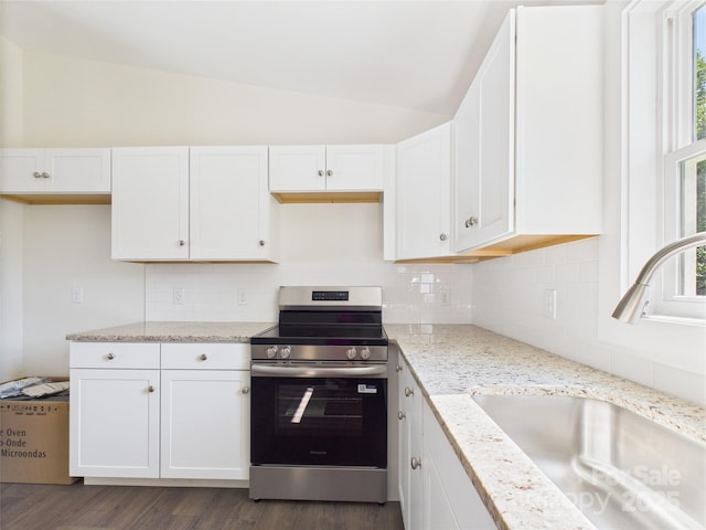 39 Pearl St, Granite Falls, NC 28630 - kitchen with stainless steel electric range oven, vaulted ceiling, white cabinets, and light stone countertops