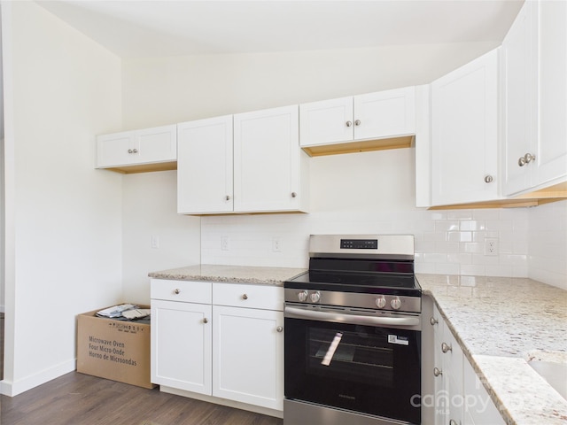 39 Pearl St, Granite Falls, NC 28630 - kitchen featuring stainless steel electric range, decorative backsplash, vaulted ceiling, white cabinetry, and light stone countertops