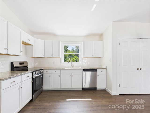 39 Pearl St, Granite Falls, NC 28630 - kitchen featuring stainless steel appliances, tasteful backsplash, white cabinets, light stone counters, and dark wood-style floors