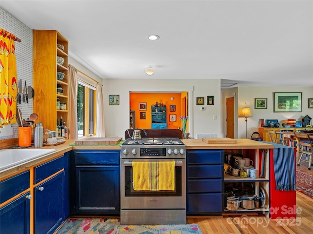 32 Sugar Cove Rd, Weaverville, NC 28787 - kitchen featuring gas stove, open shelves, light wood-type flooring, blue cabinetry, and a peninsula