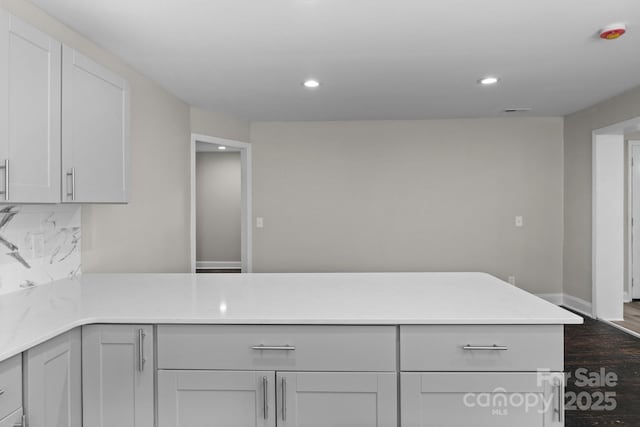 509 8th Avenue Ext, Cramerton, NC 28032 - kitchen with light countertops, decorative backsplash, recessed lighting, a peninsula, and dark wood-style floors
