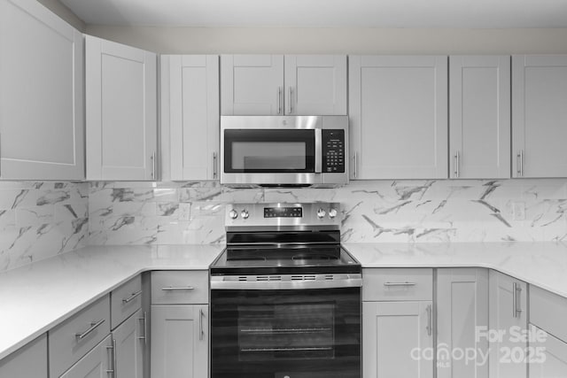 509 8th Avenue Ext, Cramerton, NC 28032 - kitchen with appliances with stainless steel finishes, light countertops, tasteful backsplash, and gray cabinetry
